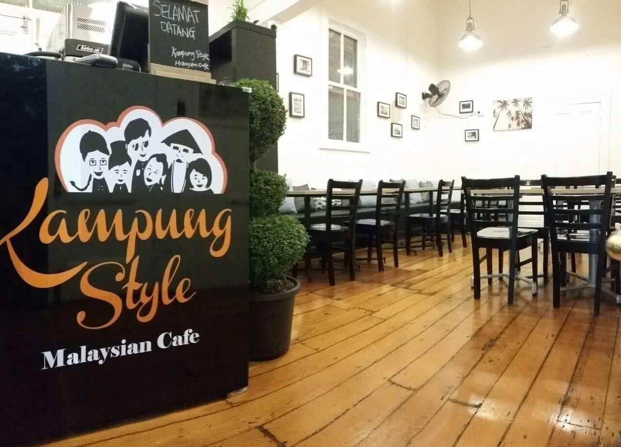 Inside Kampung Style: the hand-painted shopfront sign, timber floors and long banquette